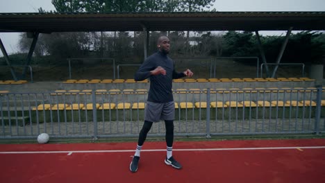 man warming up at a soccer stadium