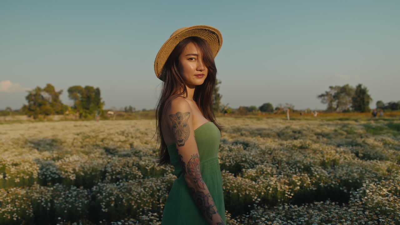 Woman in a straw hat in a flower field