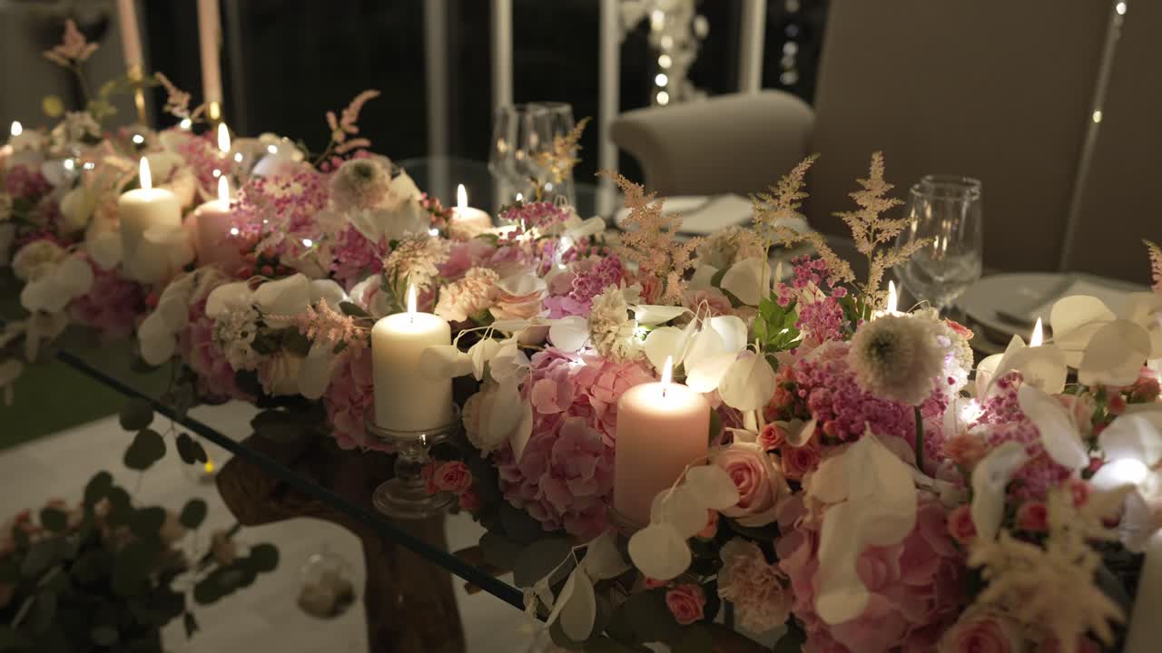 Elegante tavolo nuziale con candele e fiori in una morbida illuminazione serale interna