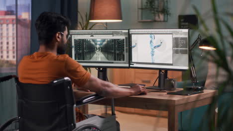 person working on 3d modeling software in a home office on a wheelchair