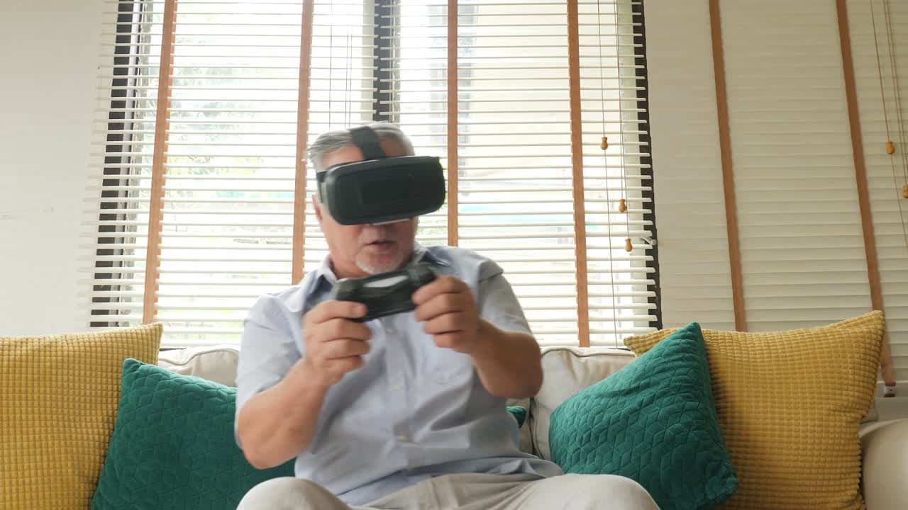 Senior man playing game at home with happy emotion. People with relaxation, old age, retirement, senior lifestyle concept.