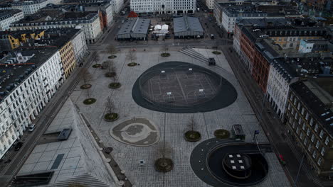 drone flying slowly over a square in copenhagen with basketball courts and a foodmarket