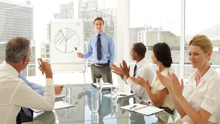Business people applauding their colleague after presentation