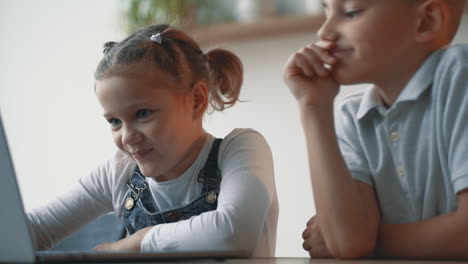 little boy and girl researching with a computer