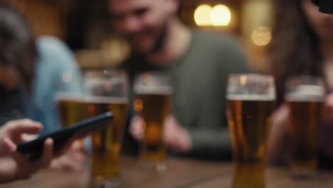 unrecognizable man paying contactless in the pub.