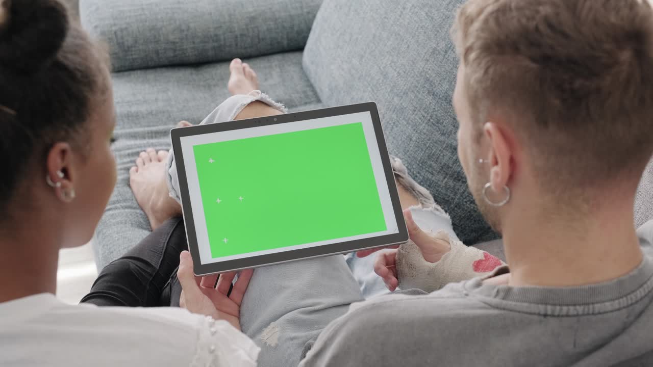 Young Man And Woman With Green Screen Of Computer