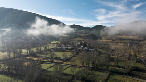 little village on the mountains of la cerdanya covered with fog