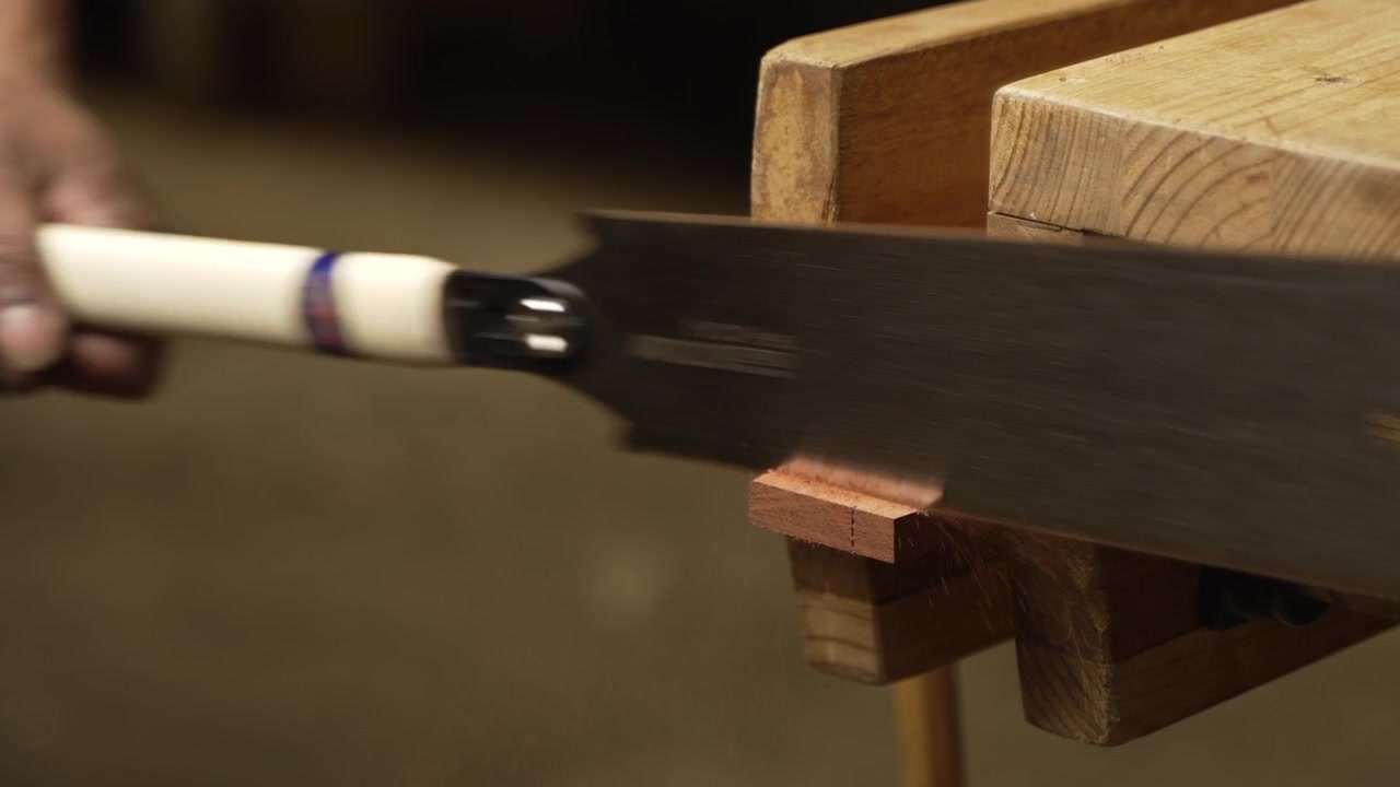 Japanese Ryoba pull saw making a cut into wood