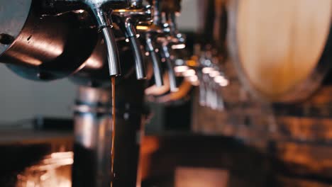 Bartender-finishes-pouring-a-dark-stout-beer-in-slow-motion,-close-up