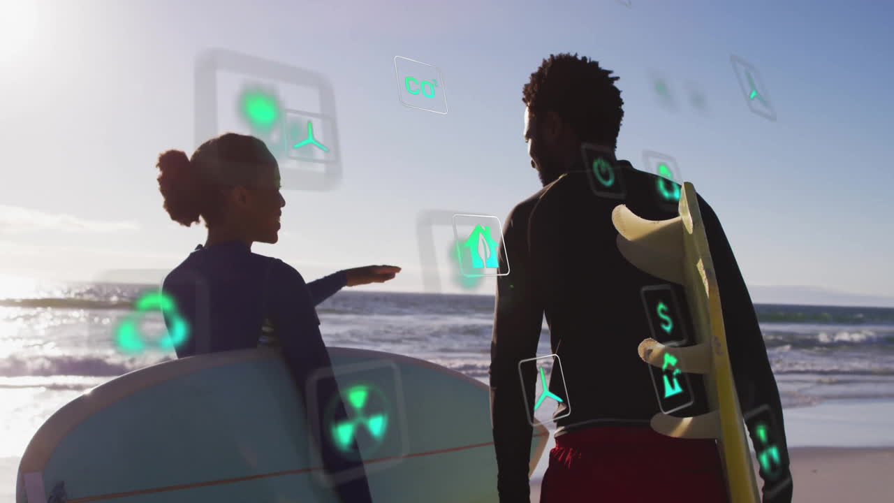 Surfers holding surfboards on beach, showing green energy icons floating around wind turbine tech