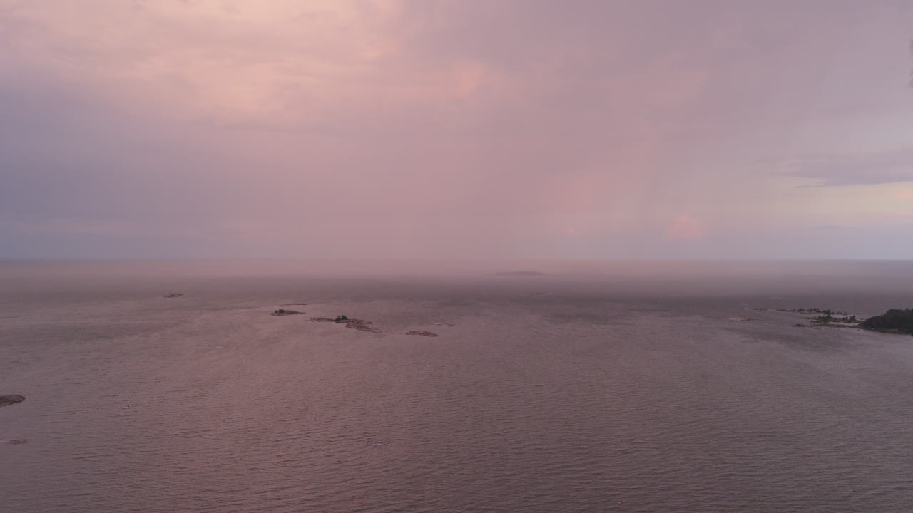 Aerial view of a rain clouds moving over the Gulf of Finland, summer sunset