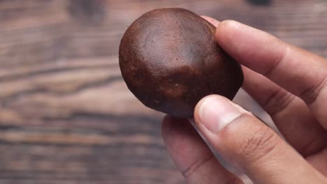 hand holding a shiitake mushroom