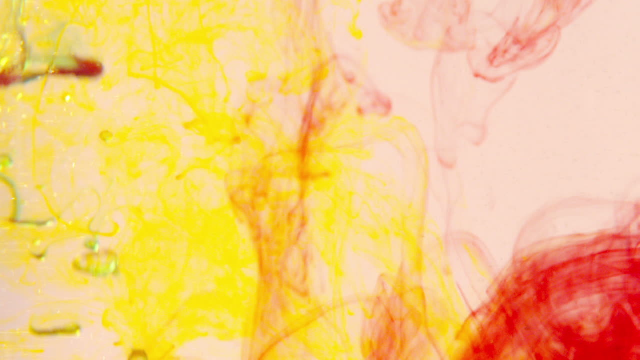 Yellow and red food coloring mixed with water and oil