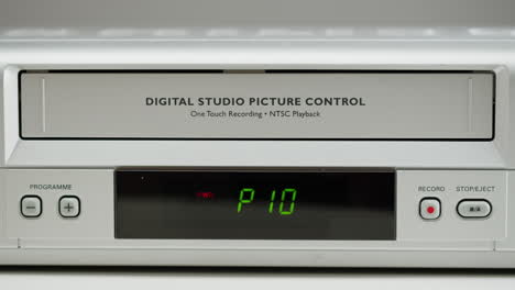 loading a vhs tape into a vintage vcr