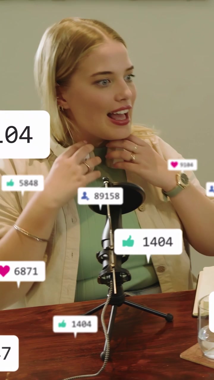 Vertical video: Woman hosting podcast speaking steadying mic while live reactions animating metrics