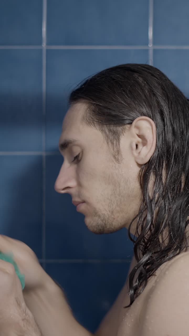 Man Showering with a Loofah