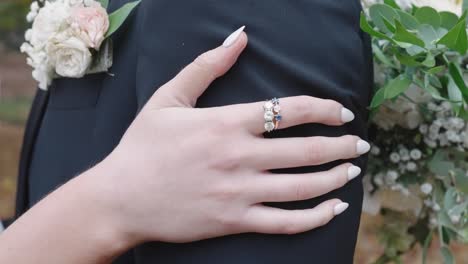 bride hand close up rubbing groom's arms in 4k slow motion