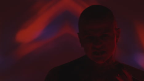 man screaming and dancing in dark studio