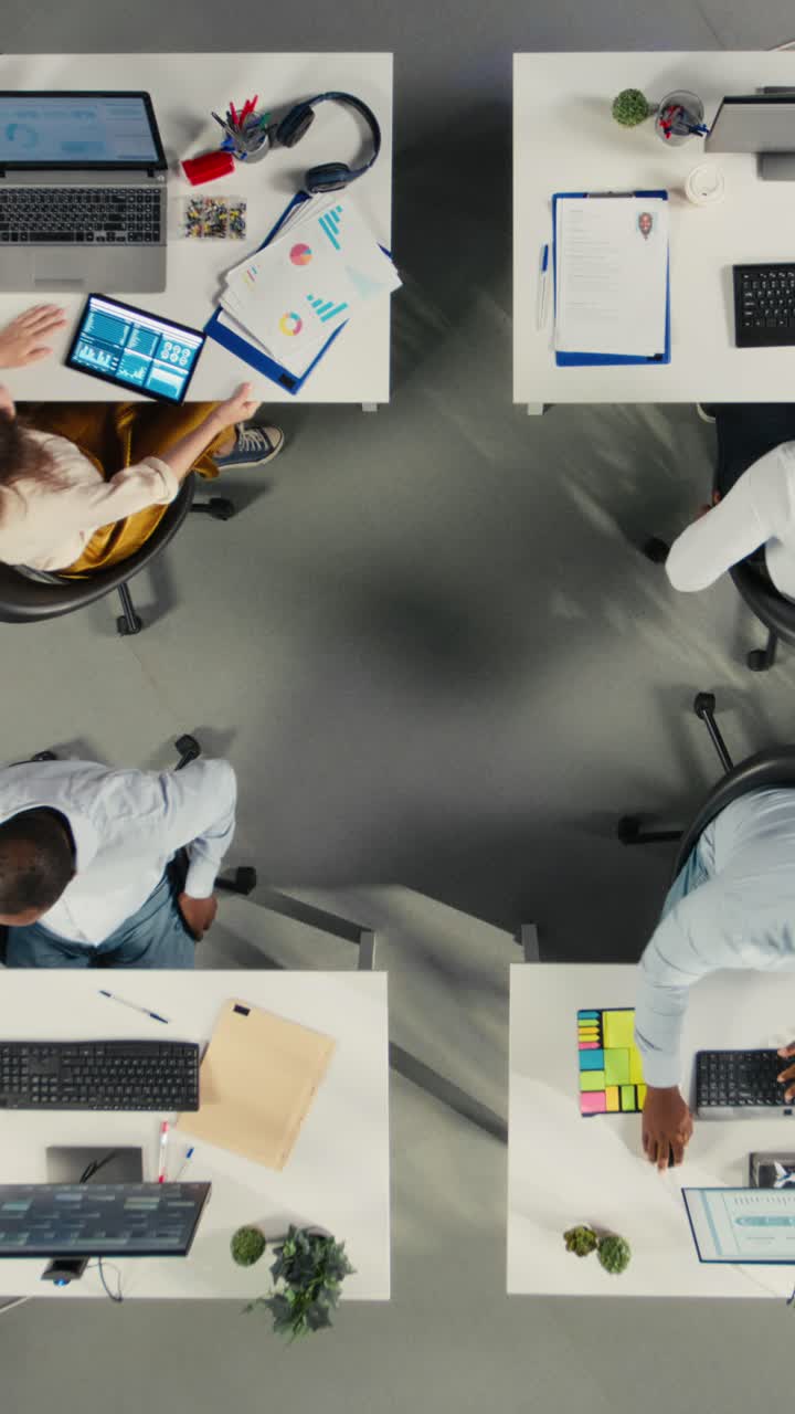 Vertical Video Top down view of business people celebrating teamwork with files and diagrams