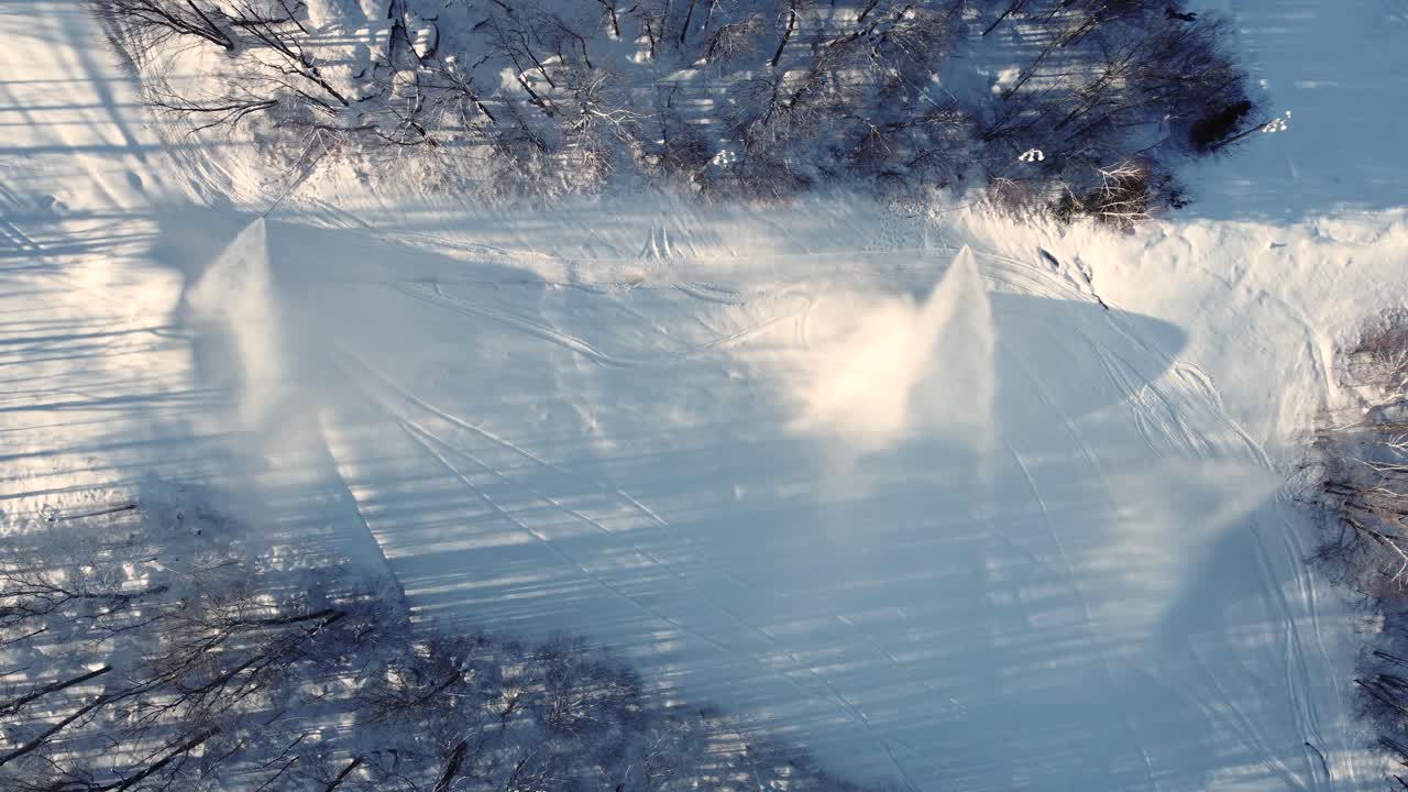 Snow cannons blasting artificial snow across ski slopes in St Sauveur, Quebec, Canada, creating a winter wonderland for enthusiastic skiers and snowboarders to enjoy