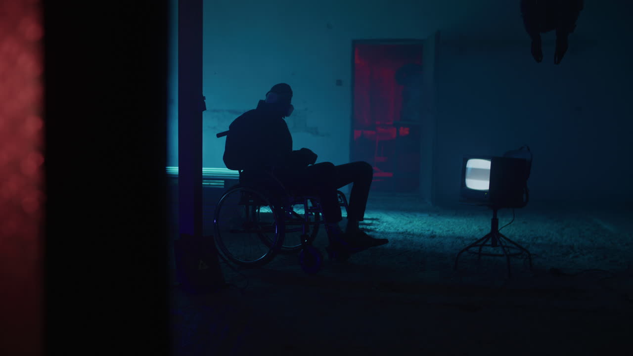 Person in Wheelchair in an Abandoned Building at Night