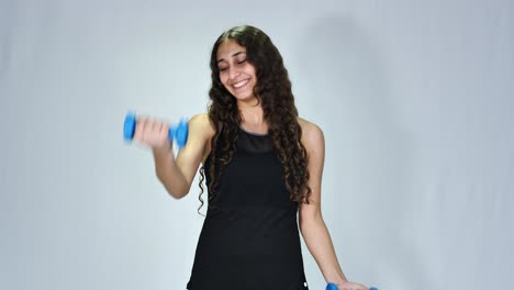 Cute-teenage-girl-exercising-with-dumbbells-isolated-on-white-background