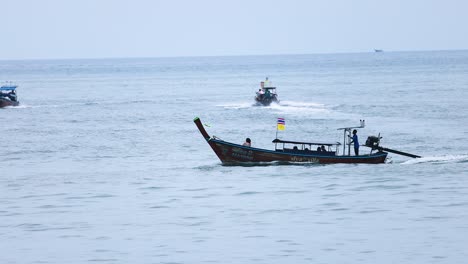 a boat moves across calm krabi waters