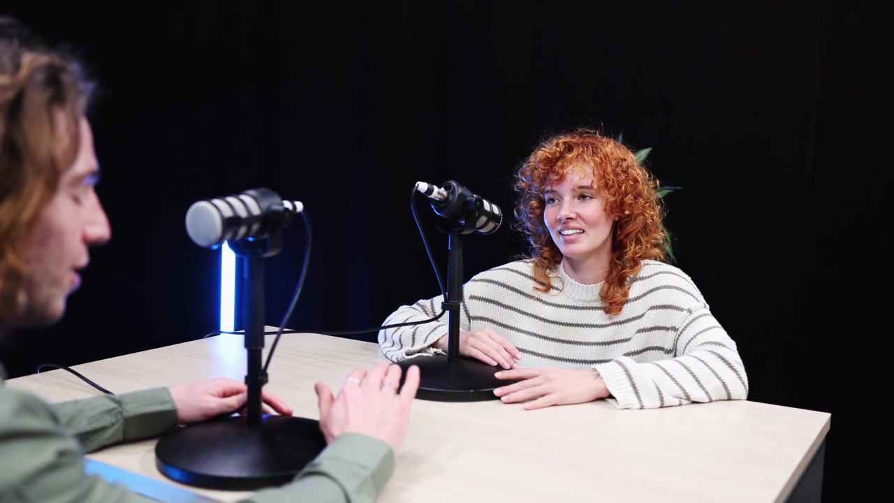 Young Woman Speaking into Microphone During Podcast Interview
