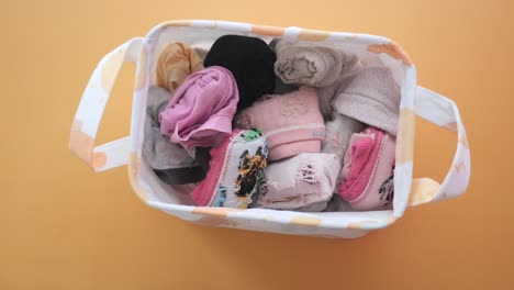 a laundry basket full of folded socks