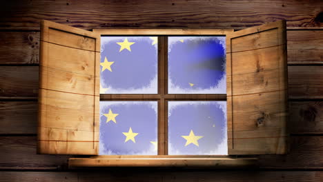 european flag floating through the window of a wooden lodge