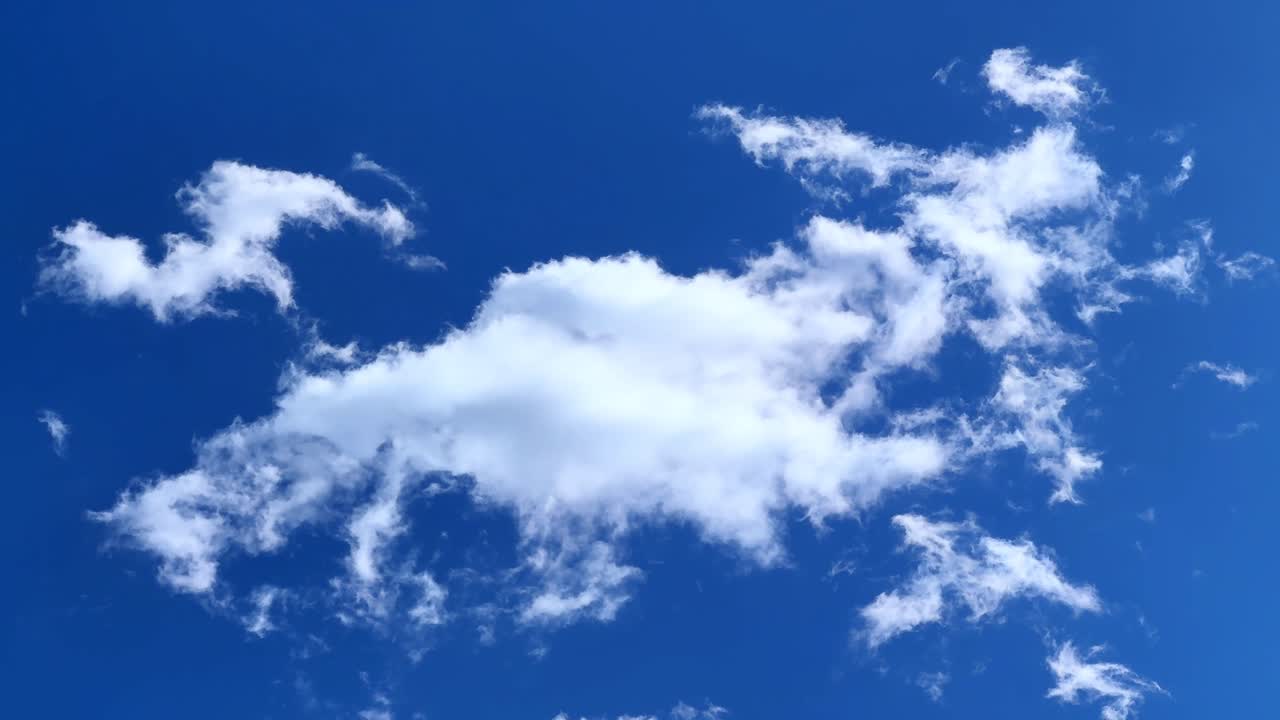 Fluffy clouds drifting across the bright blue sky in Tokyo, creating a serene view