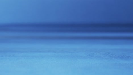 video of close up of drops of water with copy space on blue background