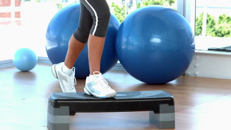 woman stepping on exercise step