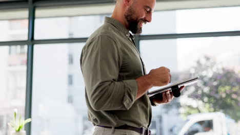 Happy-man-working-on-tablet-in-startup-office