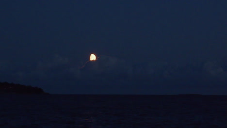 Clouds-moving-over-the-moon-at-night-over-the-sea
