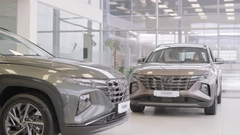 beautiful young couple at car showroom choosing a new car to buy.