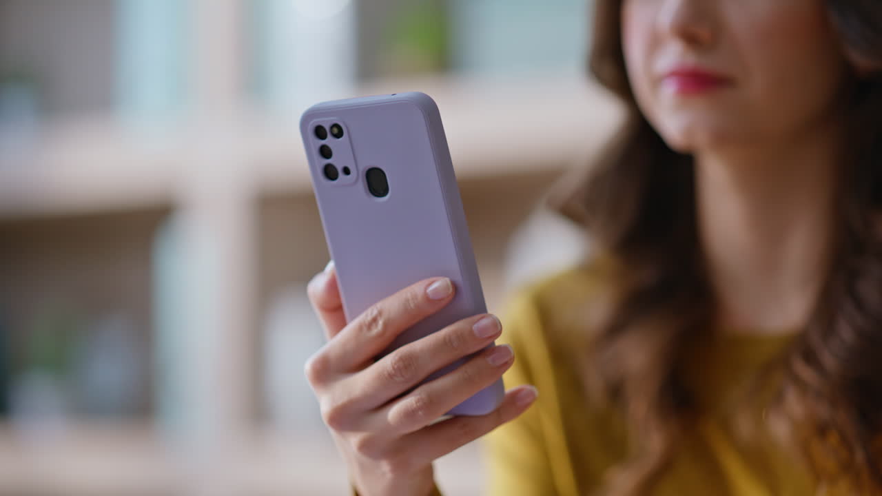 Girl browsing content cellphone sitting modern apartment closeup. Woman hand