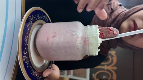 woman enjoying a strawberry smoothie