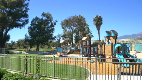 an empty playground for children in the middle of a park near the beach on a sunny day in santa barbara, california