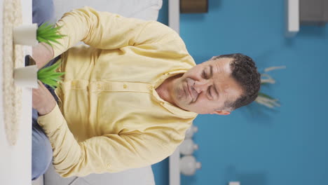 Vertical-video-of-Old-man-laughing-at-phone-message.