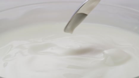 mixing yogurt with a spoon