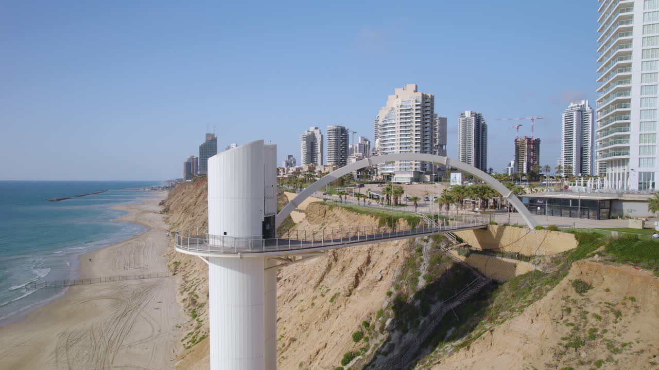Netanya city, israel sea elevator parallax drone shot reveals unique accessibility to the city’s beach and modern skyline rising on the cliff