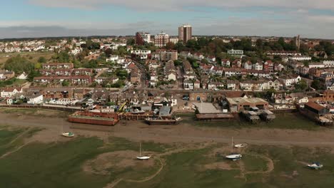 left to right motion while camera pans down then up again over coastal fishing village over marshes