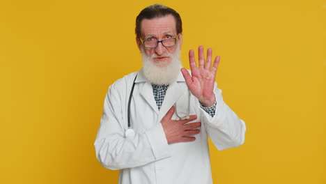 Doctor man raising hand to take oath promising to be honest and to tell truth keeping hand on chest
