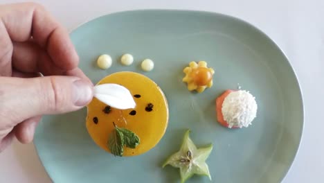 Hand-of-chef-garnishing-dessert-food