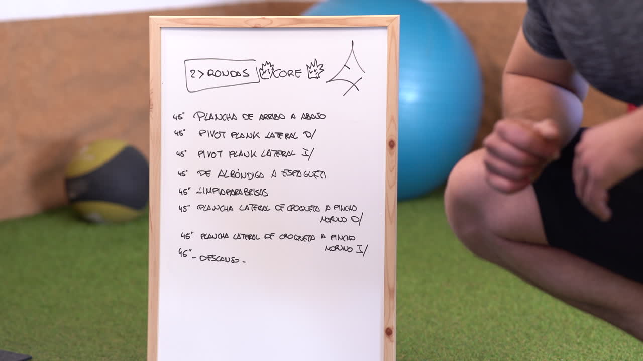 coach explaining exercise routine posted on white board