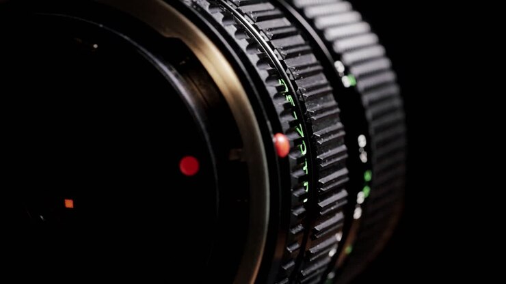 Rotating vintage 35mm to 70mm zoom camera lens lying flat with knurled rings