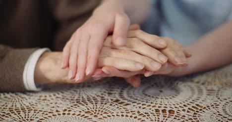 woman comforting wrinkled old hand 5