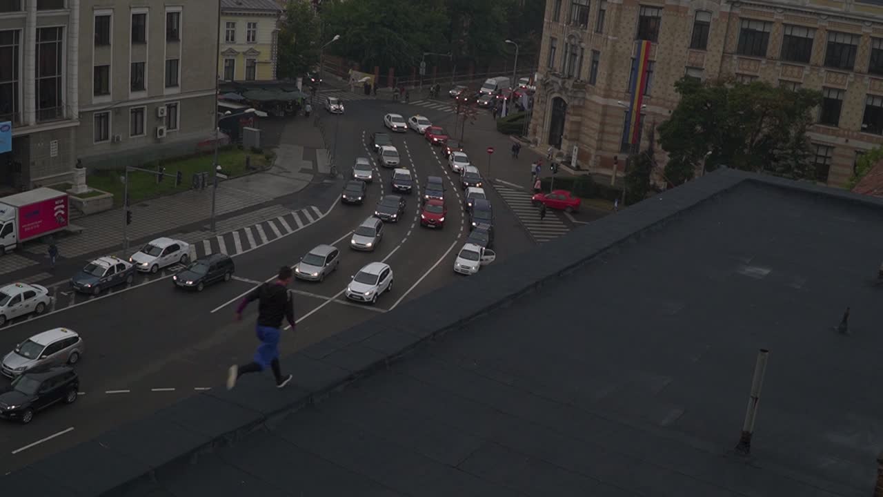 Man Running on Rooftop in Busy City