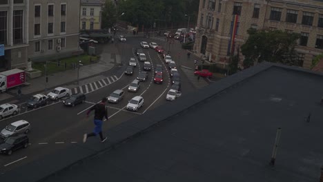 man running on rooftop in busy city